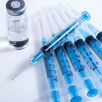 A row of syringes on a table