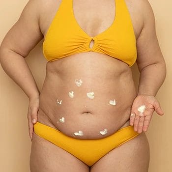 A woman with different spot of vaseline on her belly