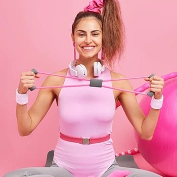 A woman holding exercise equipments