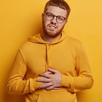 A man holding his stomach from being hungry