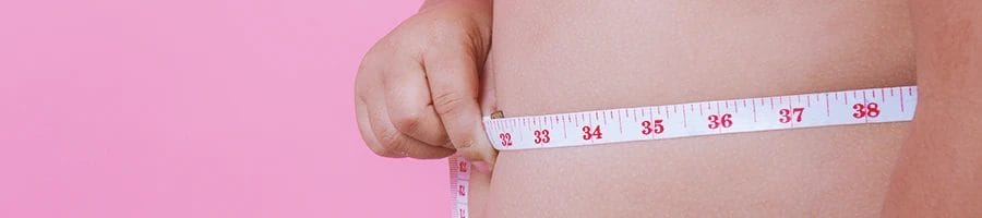 A person measuring his belly size