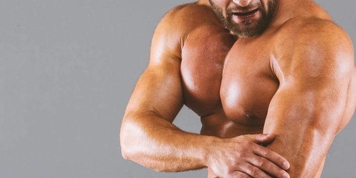 A buff person flexing and holding his bicep