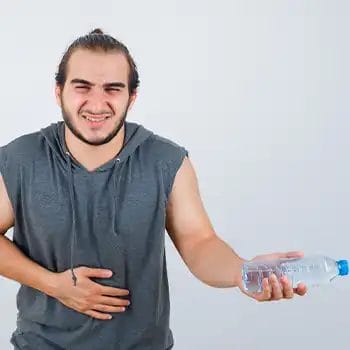 A bloated person drinking too much water