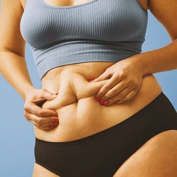 A person squishing their belly fat