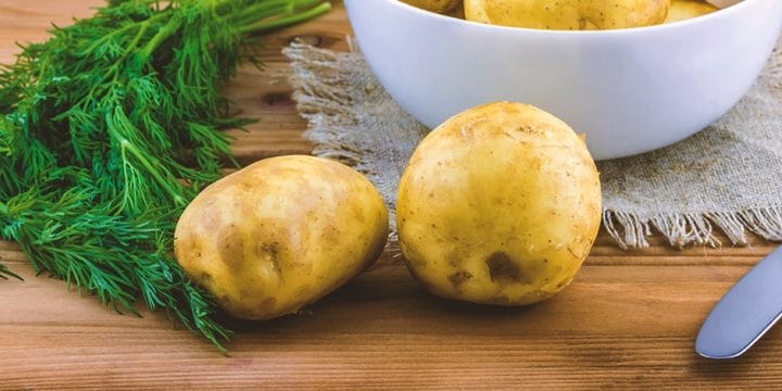Close up shot of two potatoes on a table