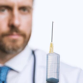 Close up shot of a doctor holding a steroid syringe