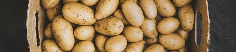 Top view of raw potatoes in a box
