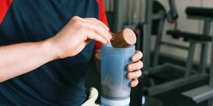 diabetic man pouring pre workout supplement in his tumbler
