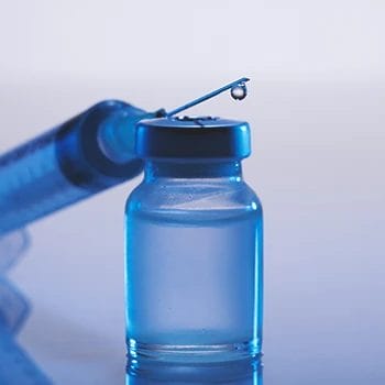 Close up shot of steroid in a bottle and syringe