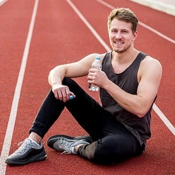 A male runner athlete drinking water