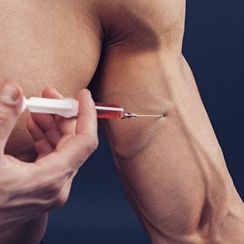 Injecting a syringe on a biceps