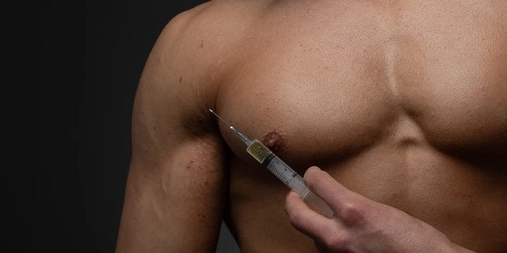 Man holding a syringe hovering on his chest
