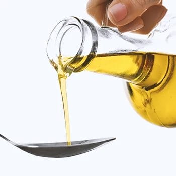 Close up shot of extra virgin olive oil being poured