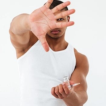 A man showing his palms while holding an injection