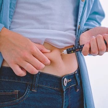 A person injecting insulin for diabetes and metabolism