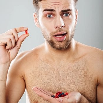 Holding a lot of supplement pills for testosterone