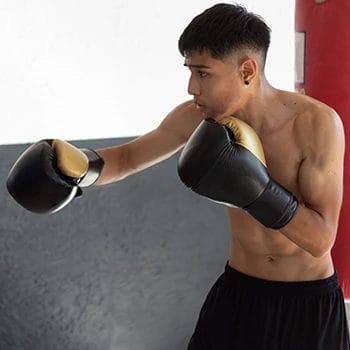 A young beginner training for boxing at a gym
