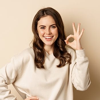 A person in good mood showing an okay hand sign