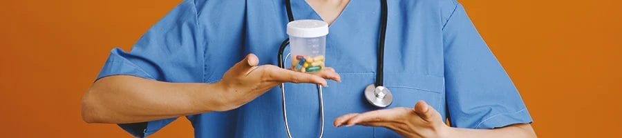 A doctor holding pills that have calming ingredients