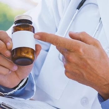 A person pointing to a bottle of nootropic pills