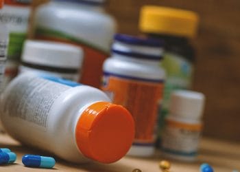 A bunch of pill bottles on a table
