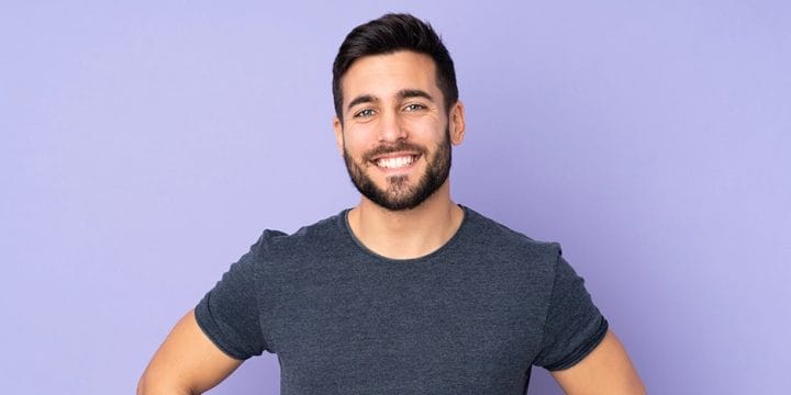 A person smiling in purple background