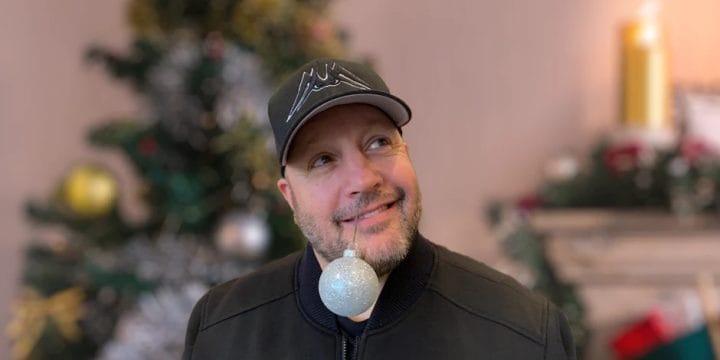 Kevin James in front of a Christmas tree