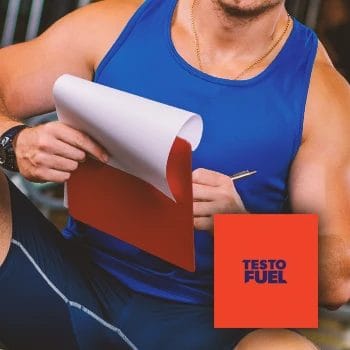 A coach in the gym holding a clipboard writing down the effectiveness of TestoFuel