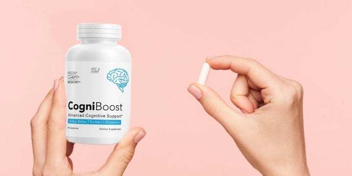 Holding a CogniBoost supplement container and a white pill