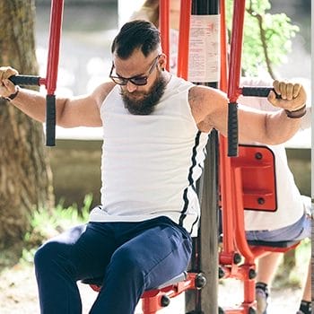 Bearded person using fly's machine outdoors