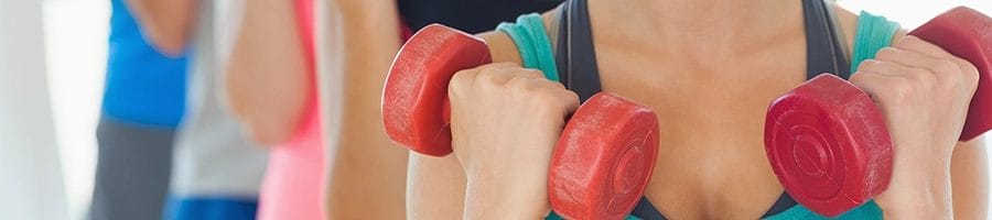 A line of athletes holding two dumbbells