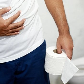 Man holding toilet paper caused by diarrhea