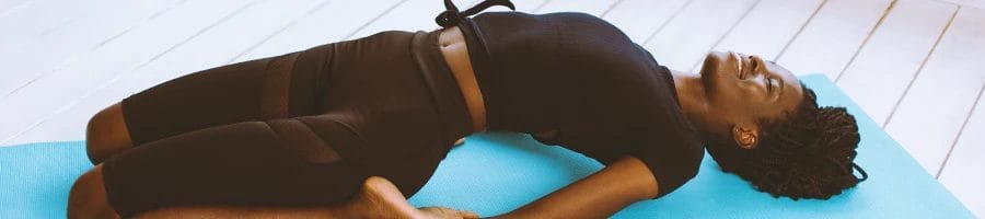 A woman doing yoga stretches on a mat