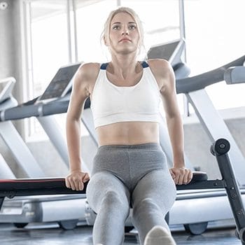 A woman doing bench dips