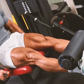 A person working out on a leg extension machine