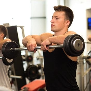 Doing upright row using barbell