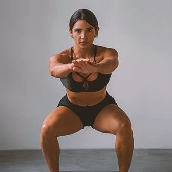A woman with good leg muscles doing a squat