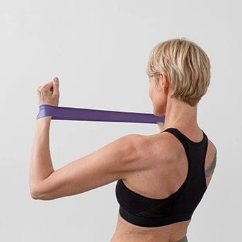 A woman pulling resistance band with two arms