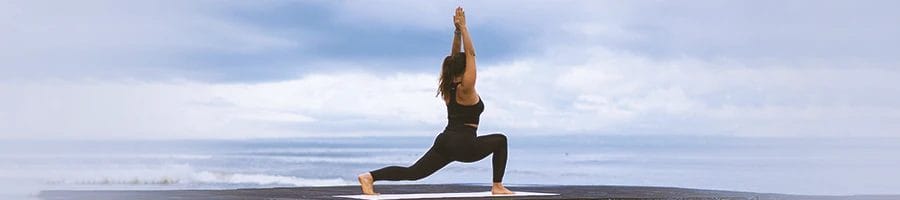 A woman doing yoga poses outside
