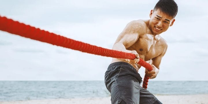 A person doing workouts with a battle rope