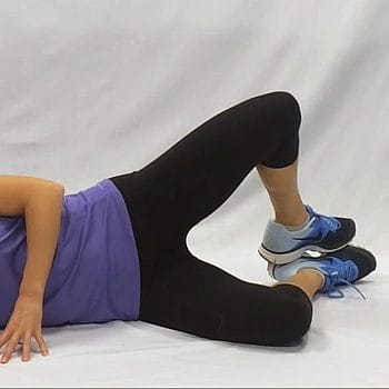 A woman performing clamshell workout