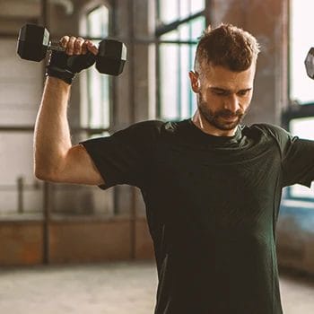 A person doing a dumbbell overhead press