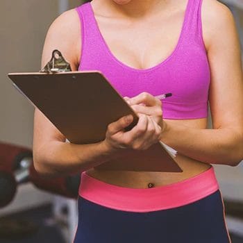 A gym instructor studying EMOM workouts