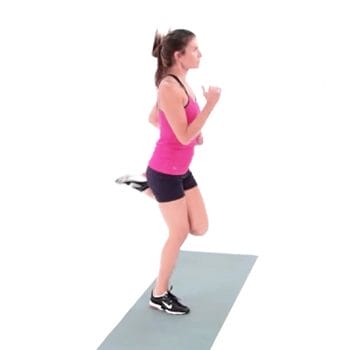 Woman doing butt kicks on a yoga mat