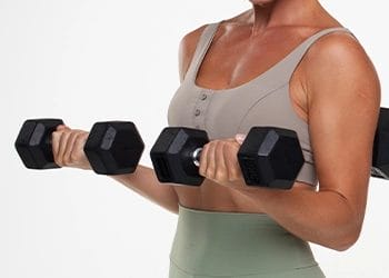 A woman doing two dumbbells for bicep muscles