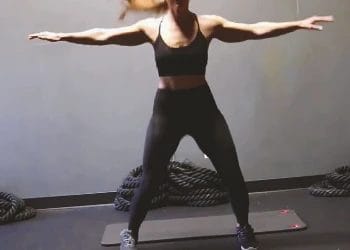 A woman doing warmups for a cross jack