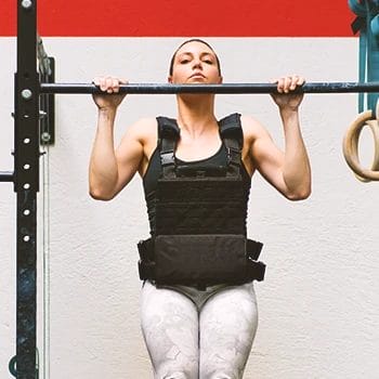 A woman doing weighted pull ups