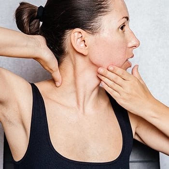 Woman showing her neck muscles while working out