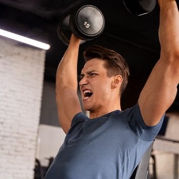 Doing dumbbell raise
