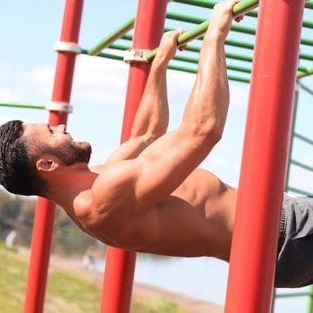 A man doing Australian Pull ups outdoors